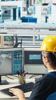 Vertical Photovoltaics factory engineer using CAD software, planning work on facility floor. Solar panels manufacturing plant technician designing assembly lines on computer, camera A video