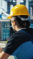 Vertical Photovoltaics factory engineer uses artificial intelligence to diagnose malfunctioning systems. Solar panel manufacturing plant worker uses AI tech to maintain system operational reliability, camera B video