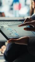 Vertical Solar panels plant employee uses CAD software on tablet to optimize layouts. Photovoltaics factory worker doing arrangements for maximum energy output using device, camera B close up video