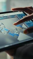 Vertical Photovoltaics factory specialist designs production lines in CAD app using tablet. Solar panels plant technician uses simulation software on device to optimize production layouts, camera B closeup video