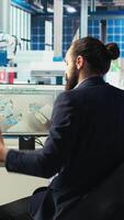 Vertical Photovoltaics factory engineer taking notes of performance after adjusting system parameters. Technician writing down adjustment to make to optimize energy supply in solar panel manufacturing plant video