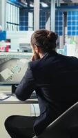 Vertical Photovoltaics factory engineer taking notes of adjustments to make after analyzing system metrics. Solar panels plant technician writing production plans after troubleshooting technical issues video