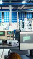 Vertical Masked worker in photovoltaics factory commits corporate espionage, stealing proprietary technology using USB stick. Man exploits insider access to copy trade secrets from solar panel plant, camera A video