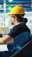 Vertical Photovoltaics factory manager shows engineer improvements to be made of robot arms manufacturing solar panels. Man shows technician upgrades needed after inspecting solar plant machinery, camera A video