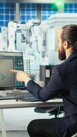 Vertical Photovoltaics factory manager visualizes solar cells designs with 3D software tools, drinking coffee. Solar panels plant technician does computer simulations in CAD program, enjoying beverage video