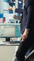 Vertical Manager arriving at work in photovoltaics factory office, analyzing data, reviewing system metrics. Man in eco friendly solar panels plant producing renewable energy troubleshooting technical issues video