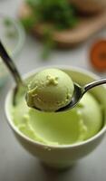 A spoon holding a scoop of ice cream photo