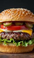 A hamburger with cheese, tomatoes and lettuce photo