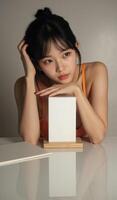 A woman sitting on a table with a blank box photo