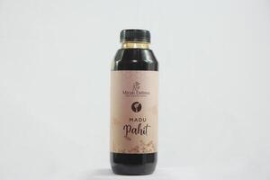 A bottle of black liquid on a white background photo