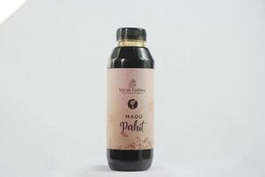 Raw organics honey in a stylish glass bottle, elegantly displayed with beeswax, fresh flowers, and a warm sunlight glow photo
