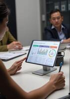 A woman is using a tablet computer in a meeting photo