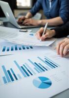 Business people working on graphs and papers photo