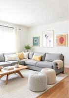 A living room with a gray sectional couch, yellow pillows and a coffee table photo