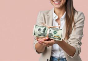 A woman in a suit holding a bundle of money photo