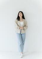 Confident Korean woman, modern casual outfit, white backdrop, fine lighting photo