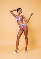 A woman in a colorful swimsuit posing photo