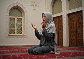 Muslim woman praying in a mosque photo