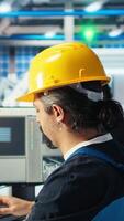 Vertical Photovoltaics factory engineer planning work on facility floor in CAD software, showing team leader. Solar panels manufacturing plant technician designing assembly lines, informing manager, camera A video