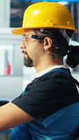 Vertical Photovoltaics factory manager showing engineer fixes to be made to repair malfunctioning systems. Man showing solar panels manufacturing plant technician upgrades needed to reduce downtime, camera B video