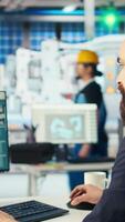 Vertical Photovoltaics factory manager delegating tasks to employee after checking performance of solar panels. Expert sending worker to make adjustments after inspecting solar plant machinery, camera A video