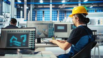 Solar panels manufacturing plant technician uses CAD program to optimize layouts. Photovoltaics factory staff member doing arrangements for maximum renewable energy output, camera A video