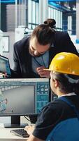 Vertical Photovoltaics factory engineer working in CAD software, brainstorming with manager. Solar panels manufacturing plant technician designing assembly lines, informing supervisor, camera A video