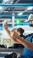 Vertical Photovoltaics factory engineer analyzing data using VR headset, reviewing system health. Solar panels plant employee troubleshooting issues using virtual reality tech, diagnosing faults, camera A video