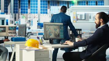Photovoltaics factory manager visualizes solar cells designs with 3D software tools, drinking coffee. Solar panels plant technician does computer simulations in CAD program, enjoying beverage video