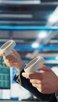 Vertical Photovoltaics factory engineer planning work on facility floor in CAD software using VR headset. Solar panels manufacturing plant technician designing assembly lines in virtual reality, camera A video