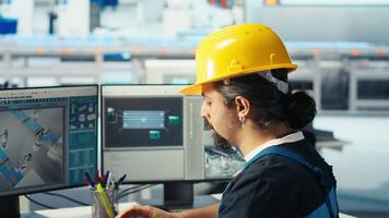 Manager instructs solar panels plant employee on how to use CAD software to optimize layouts. Photovoltaics factory supervisor teaches worker how to do arrangements for maximum energy output, camera B video