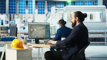 Photovoltaics factory engineer looking over paperwork documents, adjusting system parameters. Technician reading documentation files, optimizing energy supply in solar panel manufacturing plant video