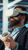 Vertical Photovoltaics factory engineer planning work on facility floor in CAD software using VR headset. Solar panels manufacturing plant technician designing assembly lines in virtual reality, camera B video
