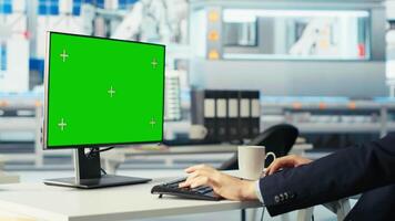 Photovoltaics factory worker analyzing data on green screen PC, reviewing system metrics. Solar panels manufacturing plant employee troubleshooting technical issues using chroma key computer, camera B video