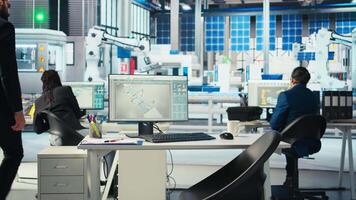 Manager arriving at work in photovoltaics factory office, analyzing data, reviewing system metrics. Man in eco friendly solar panels plant producing renewable energy troubleshooting technical issues video