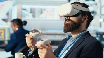 Photovoltaics factory expert using VR tech to build models of renewable energy generators. Solar panels plant technician building environmentally safe solar cells using virtual reality gear, camera B video
