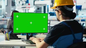 Photovoltaics factory engineer using green screen PC to adjust system parameters. Technician optimizing energy supply in solar panel manufacturing plant using chroma key computer, camera B video