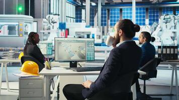 Photovoltaics factory engineer drinking coffee analyzing data, reviewing system metrics. Solar panels plant technician enjoying beverage troubleshooting technical issues using computer video