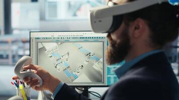 Photovoltaics factory engineer using VR goggles improving solar panels efficiency. Solar panels manufacturing plant worker using virtual reality tech researching cheaper solar solutions, camera B video