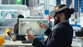 Photovoltaics factory worker using VR headset to monitor performance of robot arms placing solar panels on assembly lines. Expert inspecting solar plant machinery using virtual reality technology video
