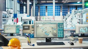 PC in photovoltaics factory used to oversee performance of robot arms placing solar panels on assembly lines. Dolly in of computer display in empty facility used for upgrading solar plant machinery video