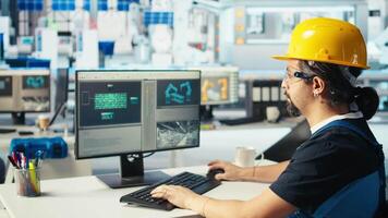 Photovoltaics factory engineer wearing yellow hardhat analyzing data, reviewing system metrics. Solar panels plant technician troubleshooting technical issues using computer software, camera A video
