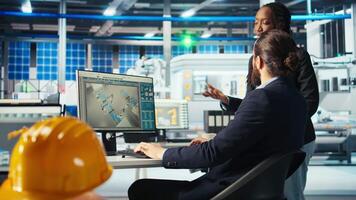 Photovoltaics factory team leader gives workers tasks after analyzing system health metrics. Solar panels plant manager tells employees fixes to make after troubleshooting technical issues, camera A video