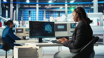 System administrator in photovoltaics factory using AI to diagnose malfunctioning systems. Solar panels manufacturing plant software developer reducing downtime using artificial intelligence, camera A video