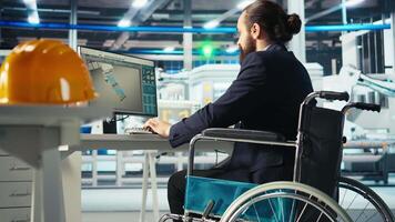 Person with disability in photovoltaics factory diagnosing malfunctioning systems. Solar panels plant worker with paraplegia in wheelchair maintaining system operational reliability, camera A video