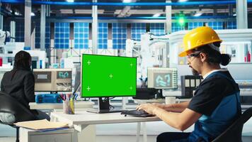 Engineer in solar panels plant using CAD software on mockup PC to optimize layouts. Photovoltaics factory worker using green screen computer to do arrangements for maximum energy output, camera A video