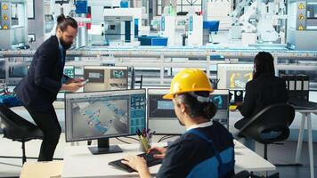 Manager instructs solar panels plant employee on how to use CAD software to optimize layouts. Photovoltaics factory supervisor teaches worker how to do arrangements for maximum energy output, camera A video