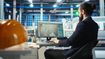 Photovoltaics factory engineer looking over paperwork documents, analyzing data. Solar panels manufacturing plant employee reading documentation files, troubleshooting technical issues, camera A video