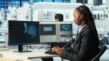 Photovoltaics factory programmer analyzing data using artificial intelligence, reviewing system metrics. Solar panels plant technician troubleshooting technical issues using AI technology, camera B video