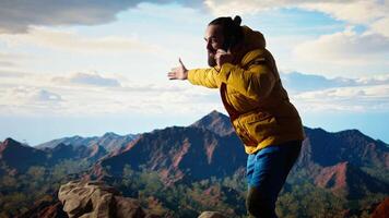 Clumsy foolish hiker dropping his phone in search of signal on mountain top, his lack of attention causes an accident in the nature. Reckless person unprepared tumbling. Camera A. video